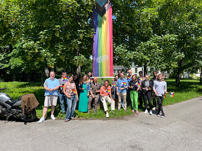Die Mitatbeiter:innen der Zentrale des Verein Wiener Jugendzentren hissen die Regenbogenfahne.